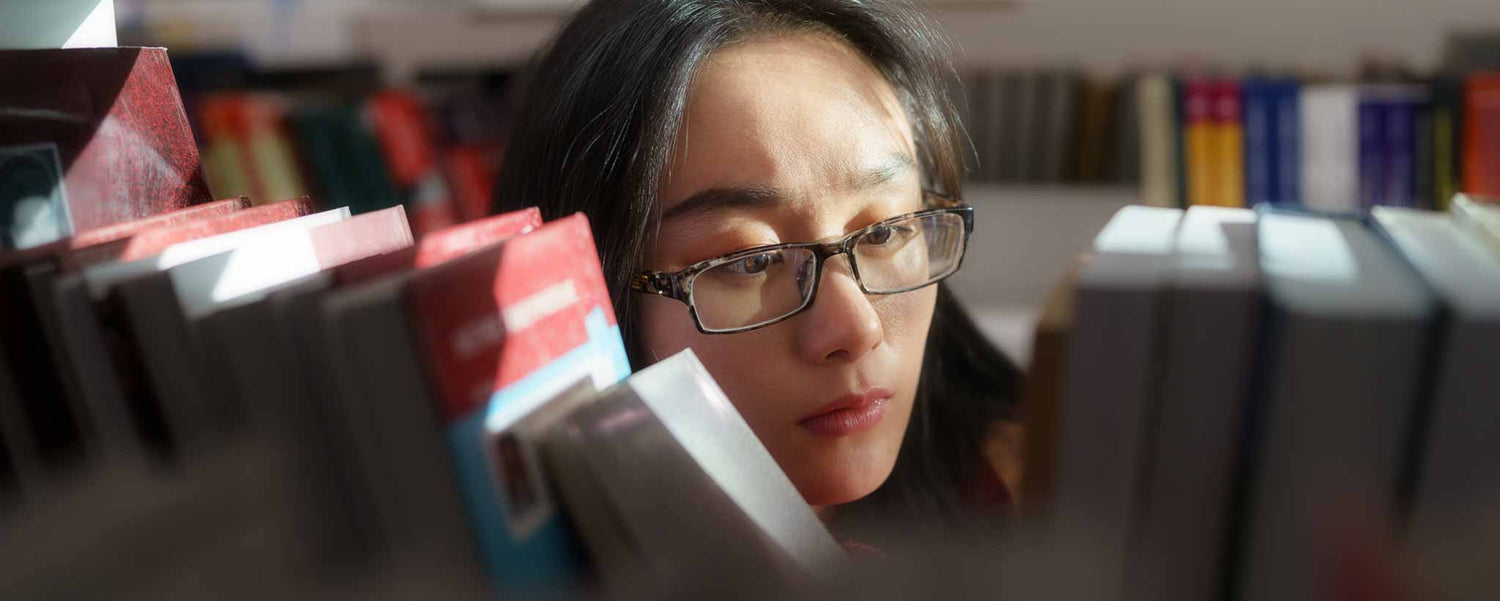 Female looking through library books
