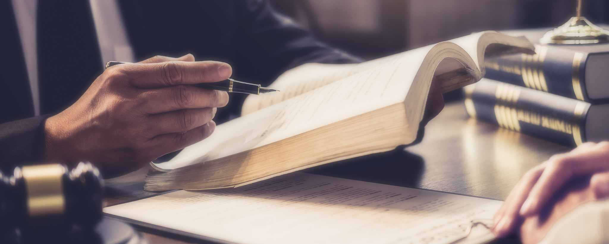 'Attorney's hand holds a law book during a patient consultation.'