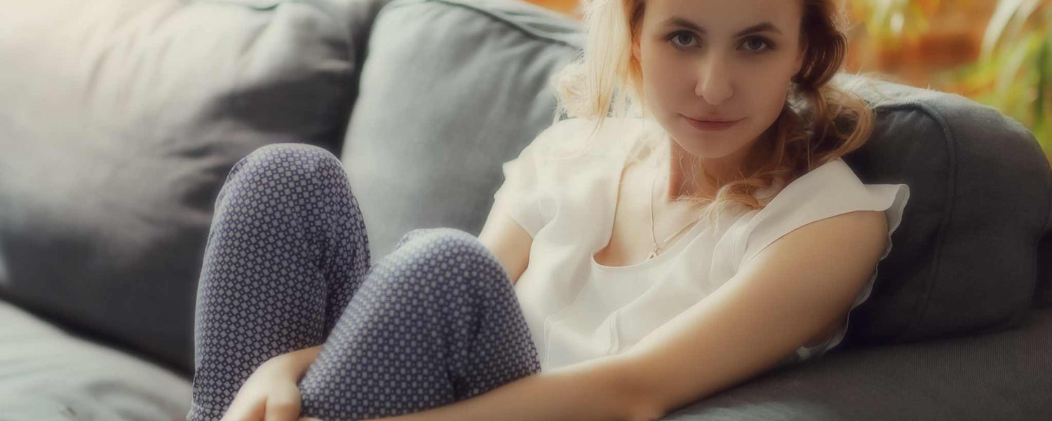Blonde female sitting on sofa