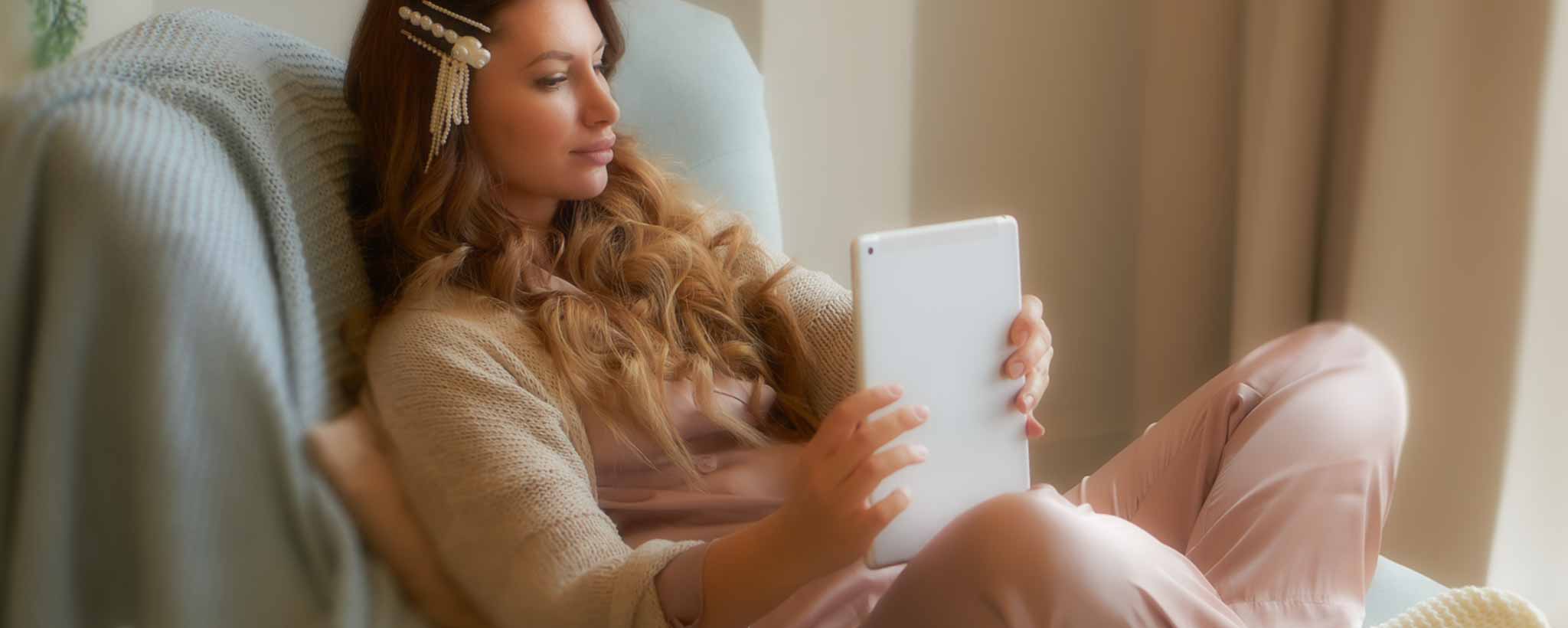 'Female reading in comfortable chair'