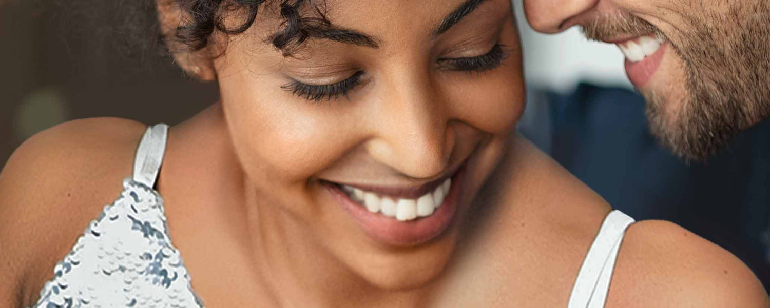 The smiling faces of a biracial couple.