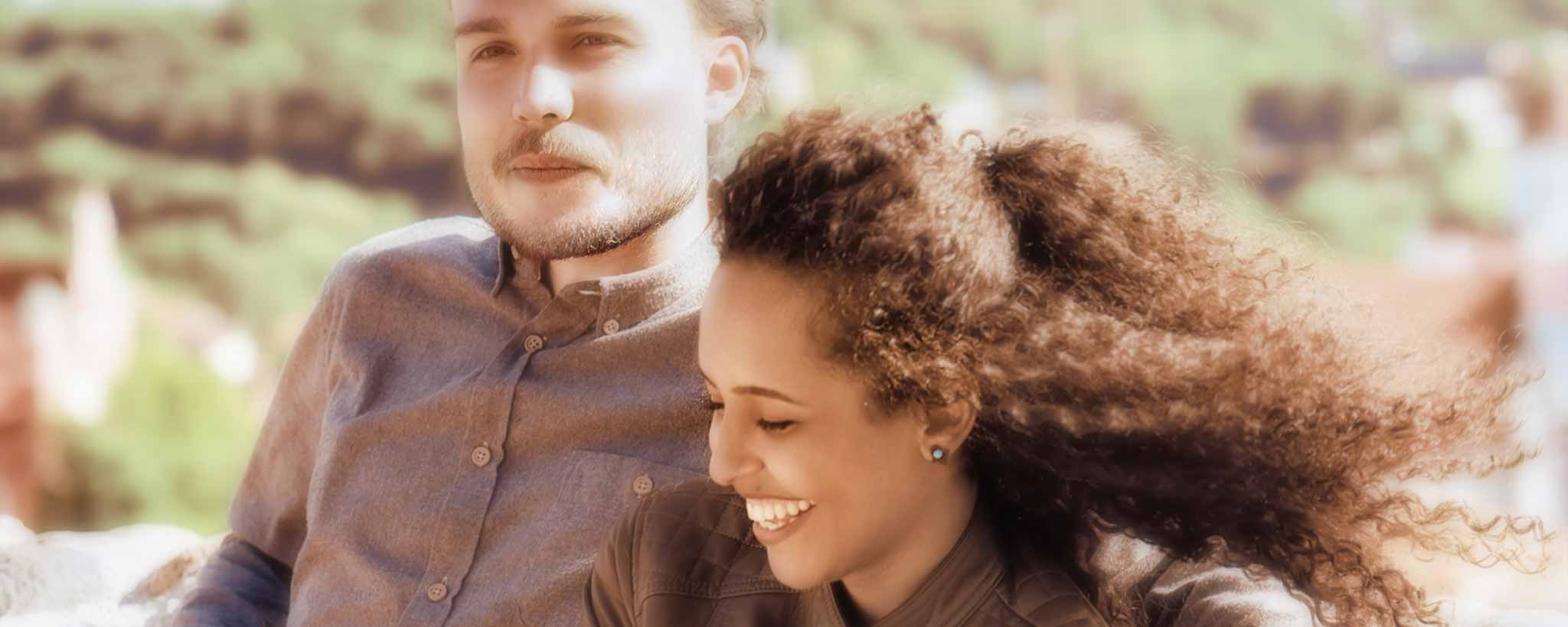 'A biracial couple outdoors.'