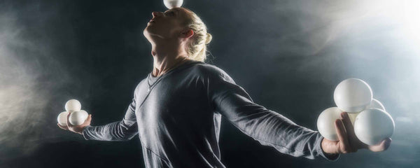 Blonde man juggling balls