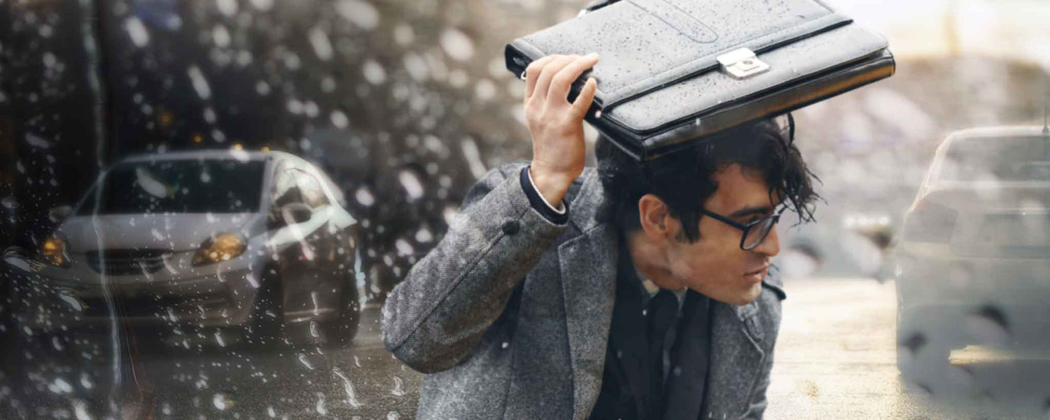 Businessman caught in the rain