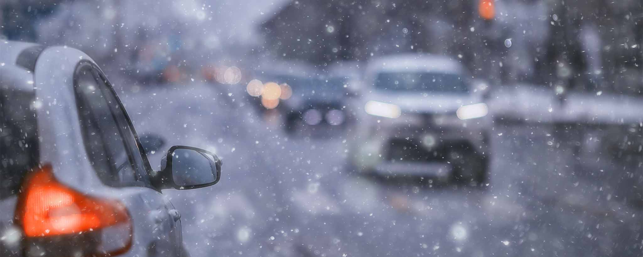'Automobiles on road in snow'