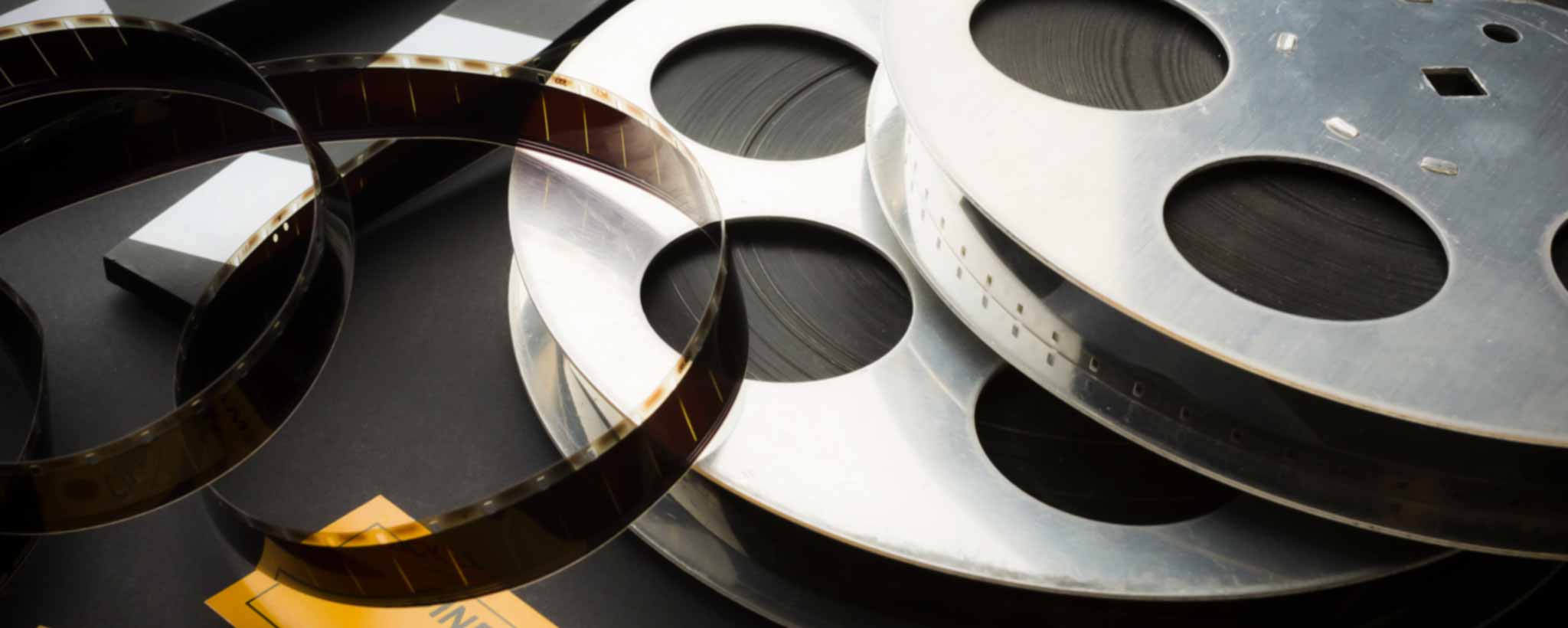 'Cinema film reels and ticks on a black table.'