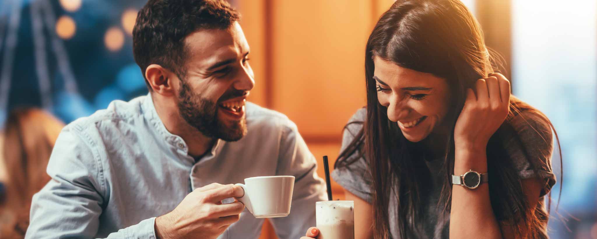 'A man and a lady are enjoying a drink together in a casual setting.'