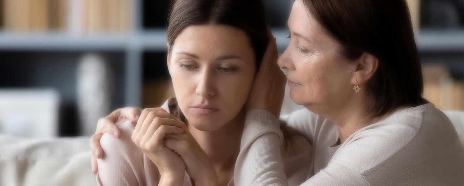 Mother comforts adult daughter