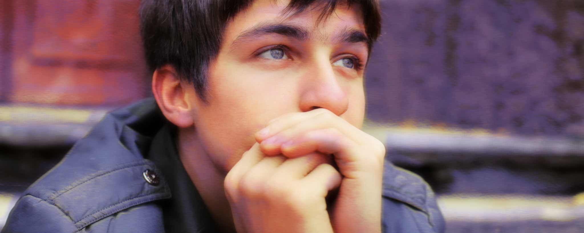 'A portrait of a contemplative teenage boy.'