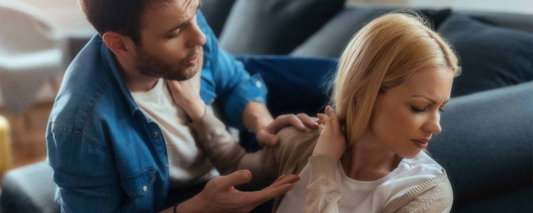 'A woman shoves her husband away.'