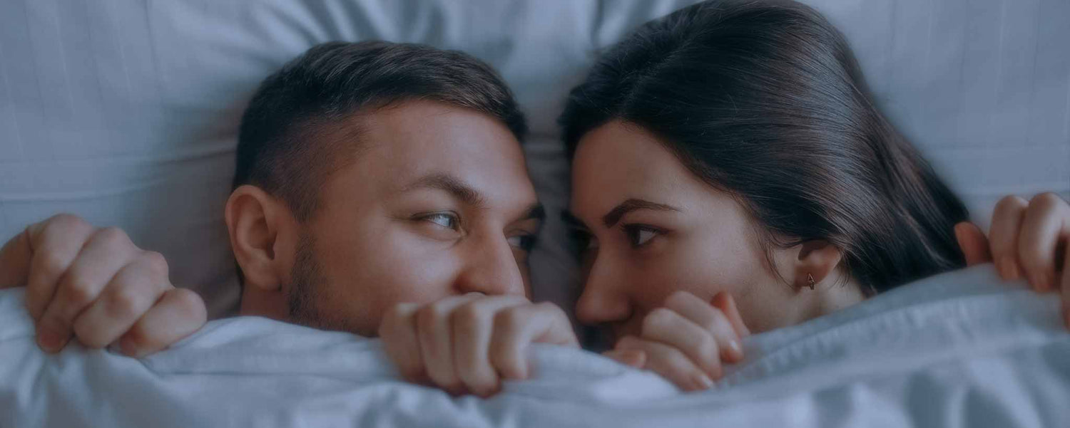Anxious couple between sheets