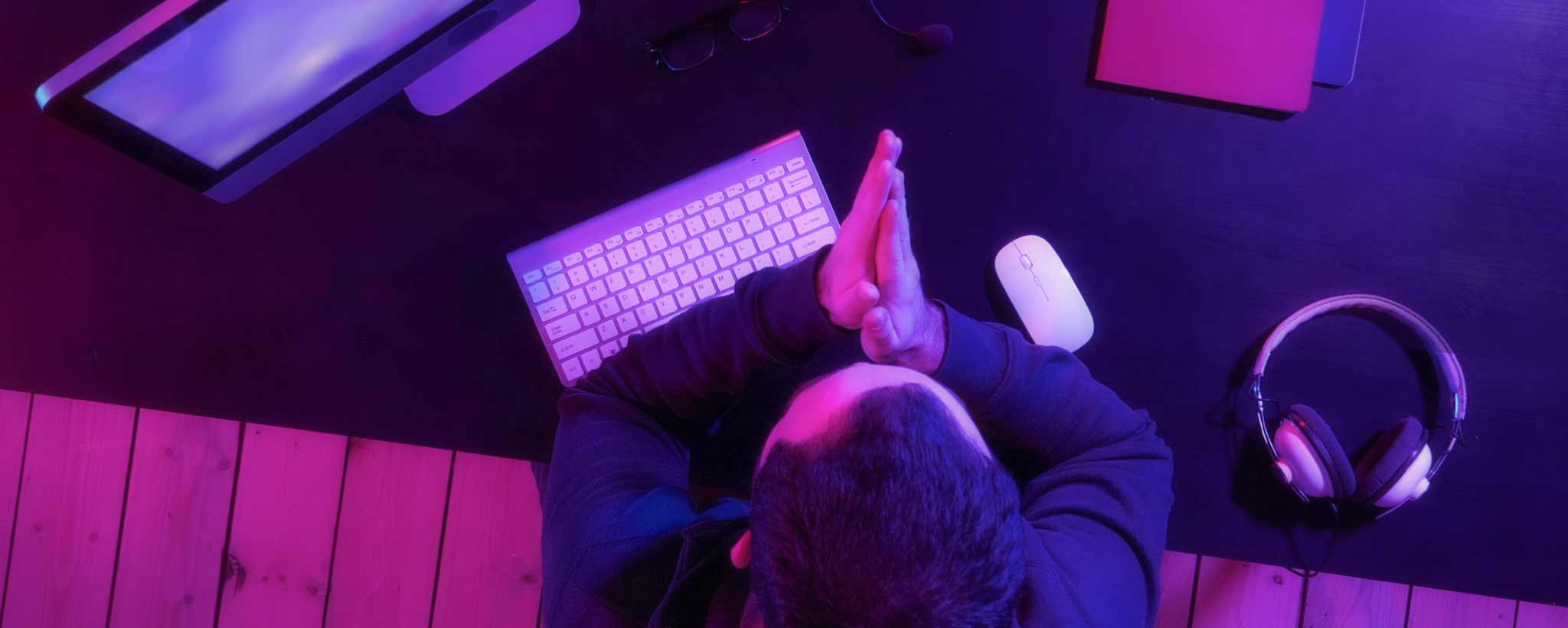 'Man sitting at computer desk'