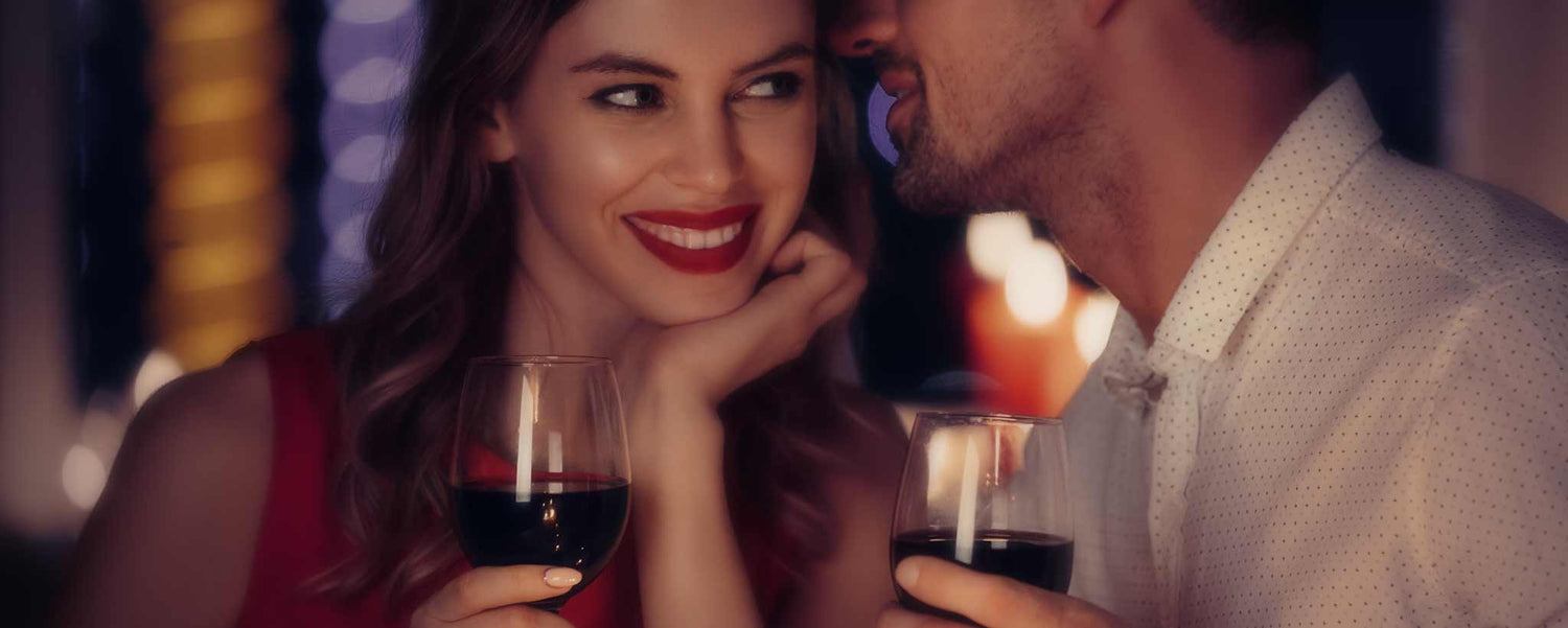 A couple enjoying wine with dinner.