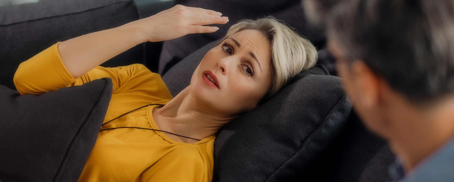 FA female mental health patient on sofa during therapy.