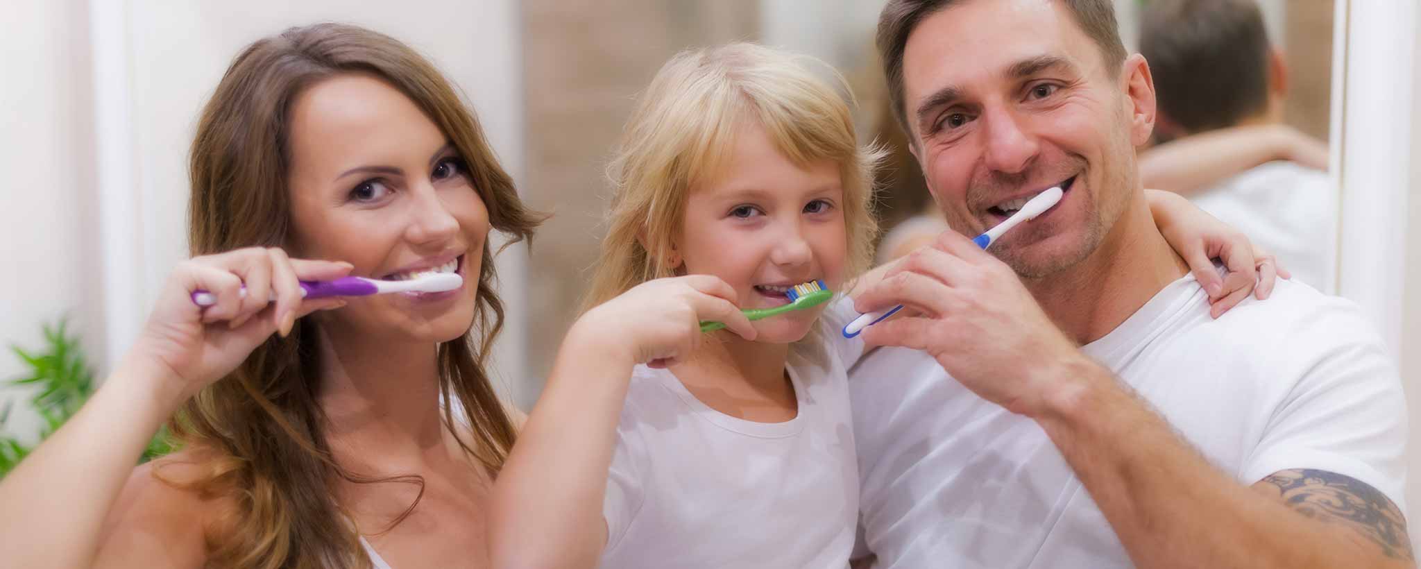 'Caucasian family brushing teeth'