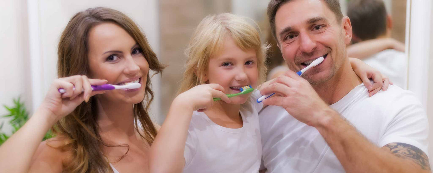 Caucasian family brushing teeth