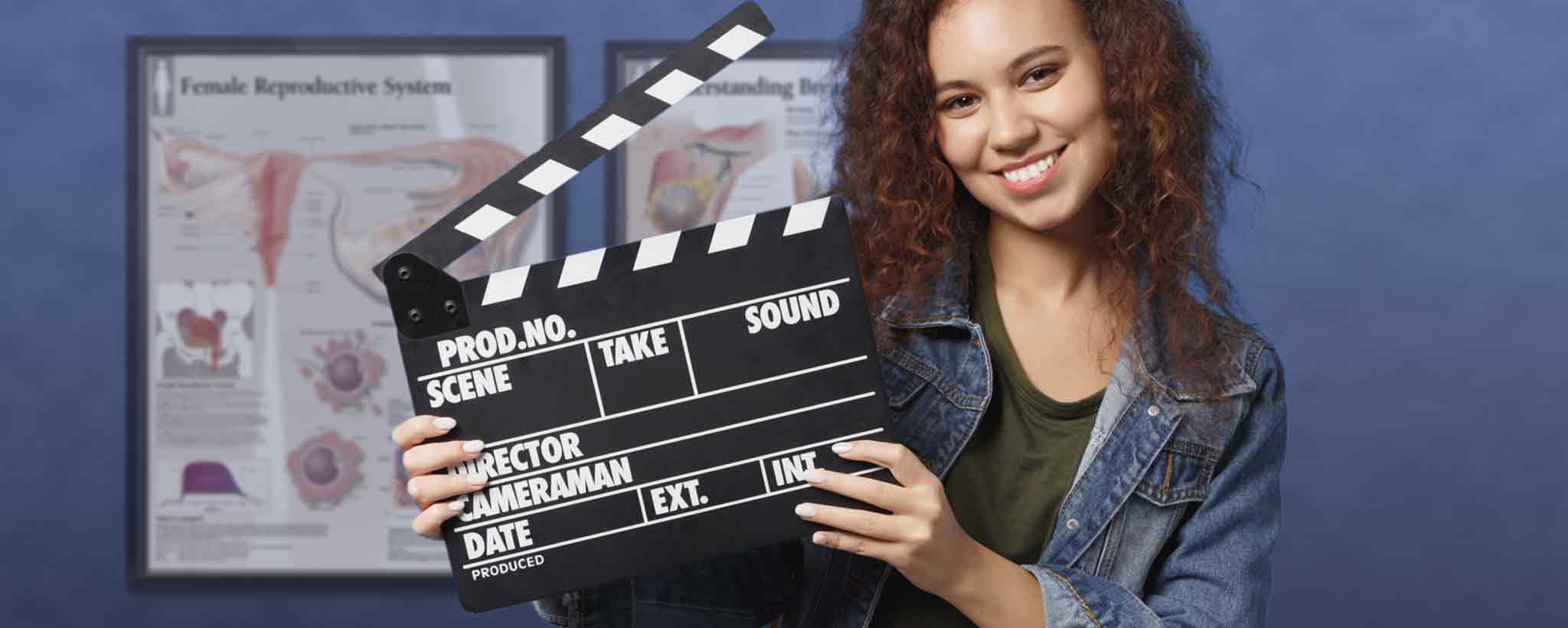 'Female holding movie clapper'