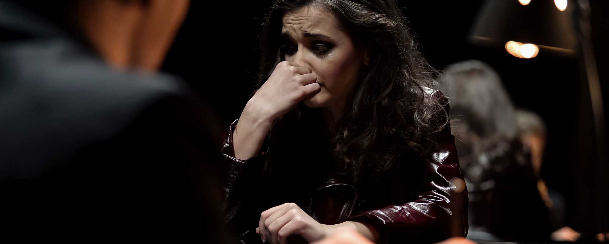 'A female crime suspect cries during interrogation.'