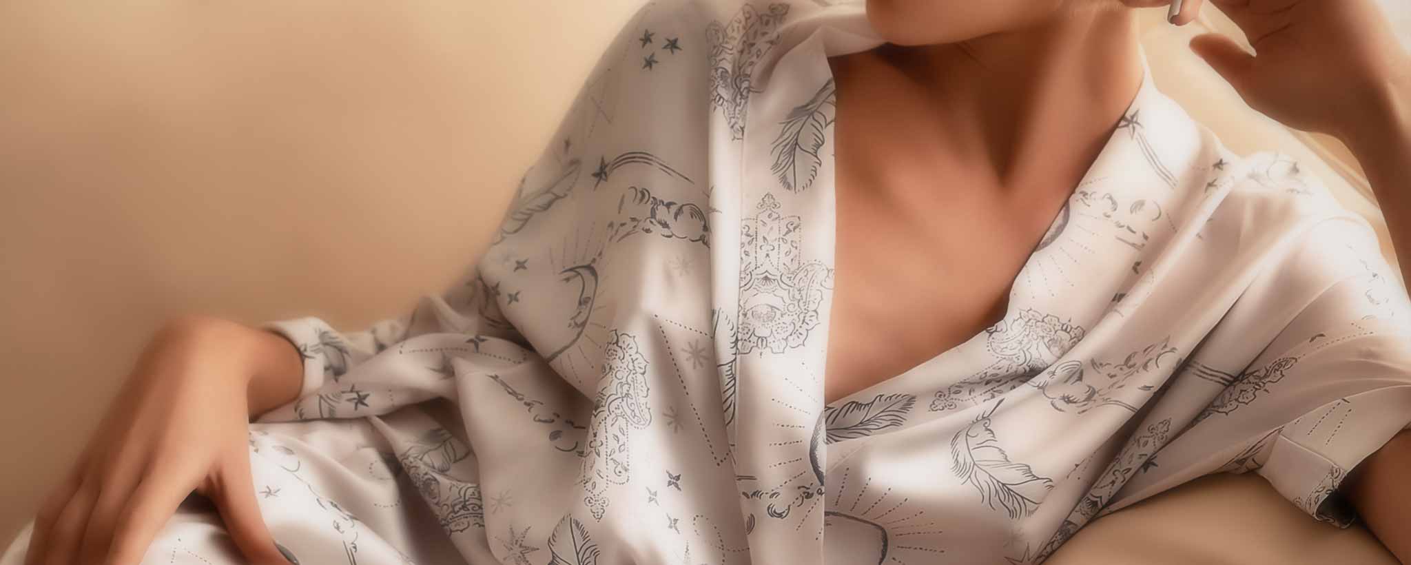 'A female reposed wearing a satin robe.'