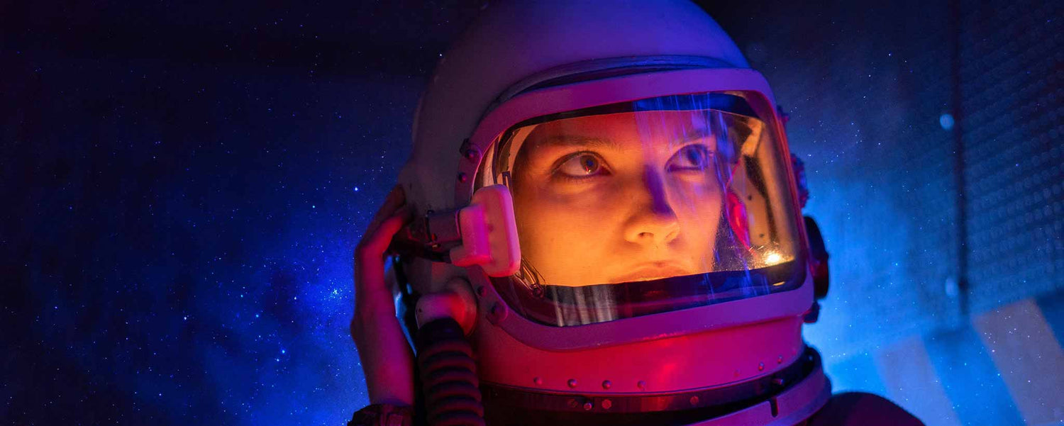 A female wearing a space helmet.