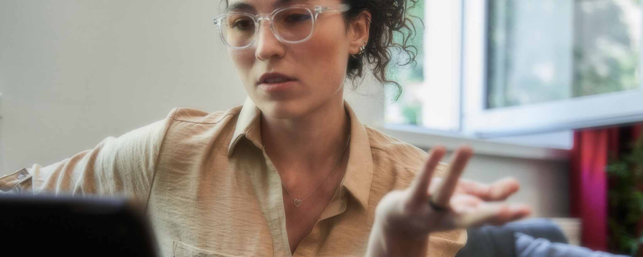 'A psychotherapist gestures during a patient meeting.'