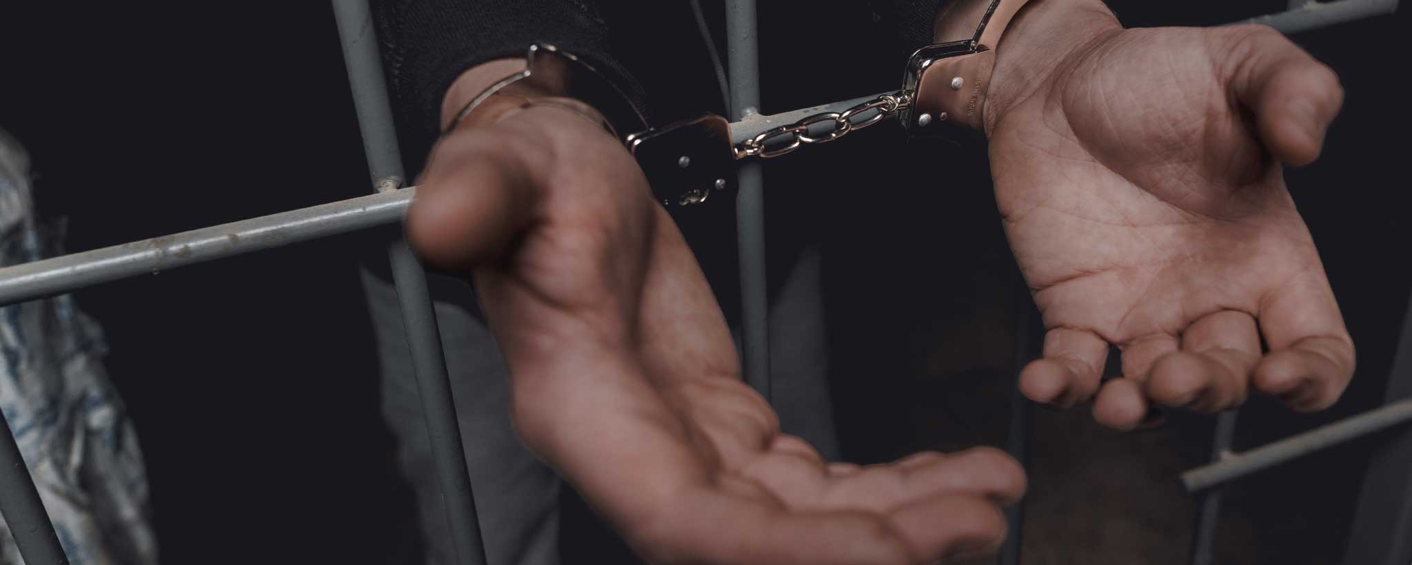 'Handcuffs behind bars'