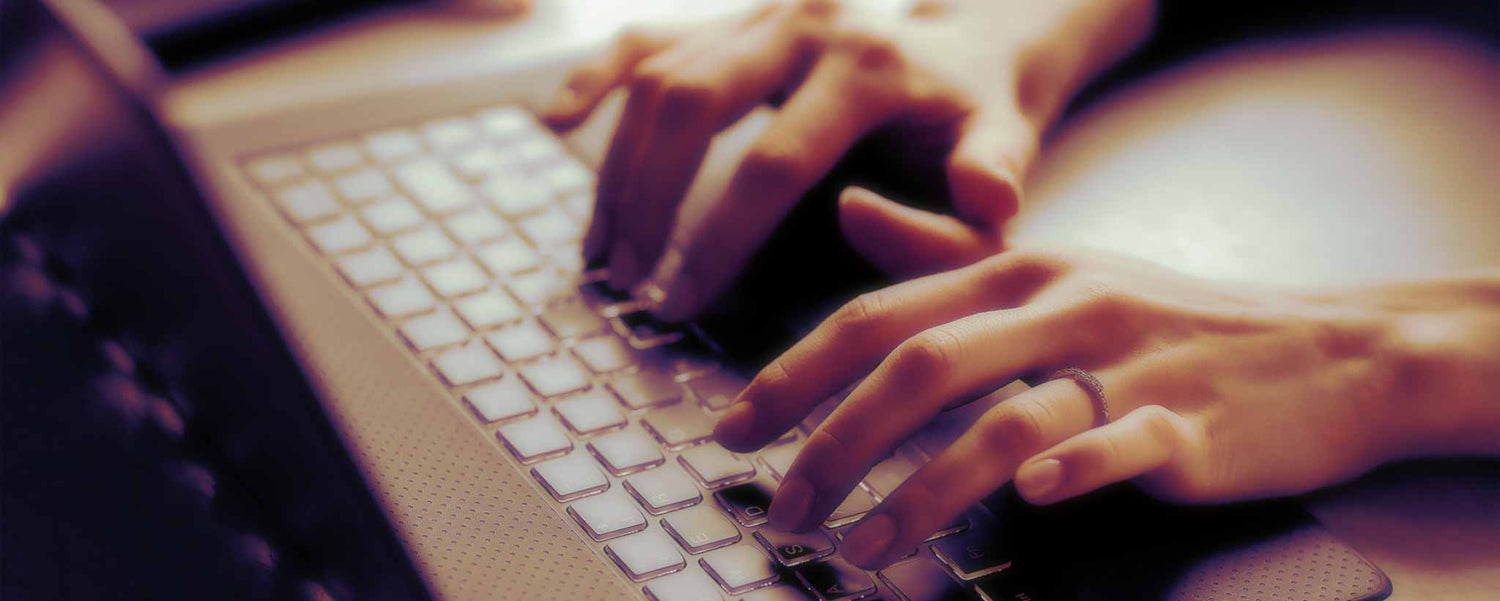 Writer typing on keyboard