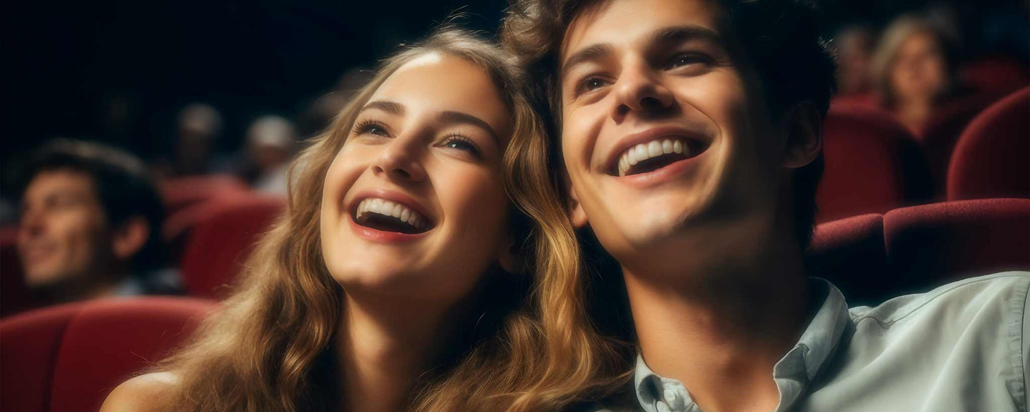 A happy young Caucasian couple in the theater. (ai)