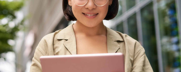 Female reads digital tablet outdoors