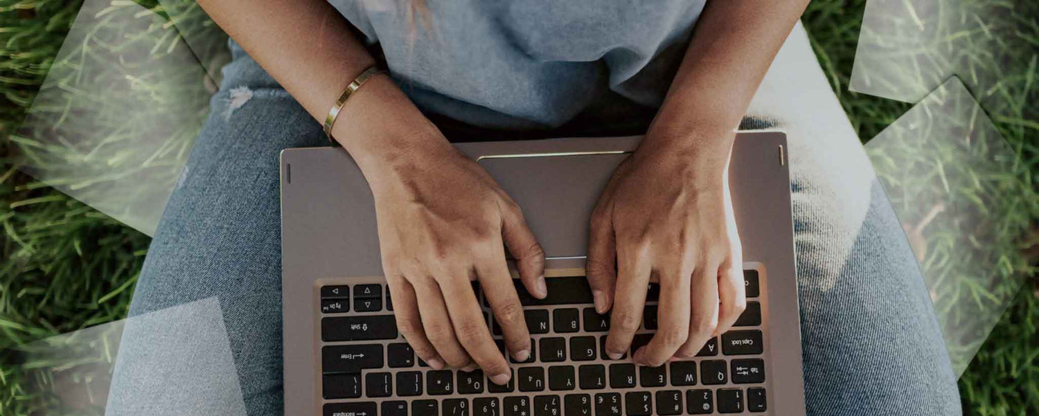 Hands typing on laptop