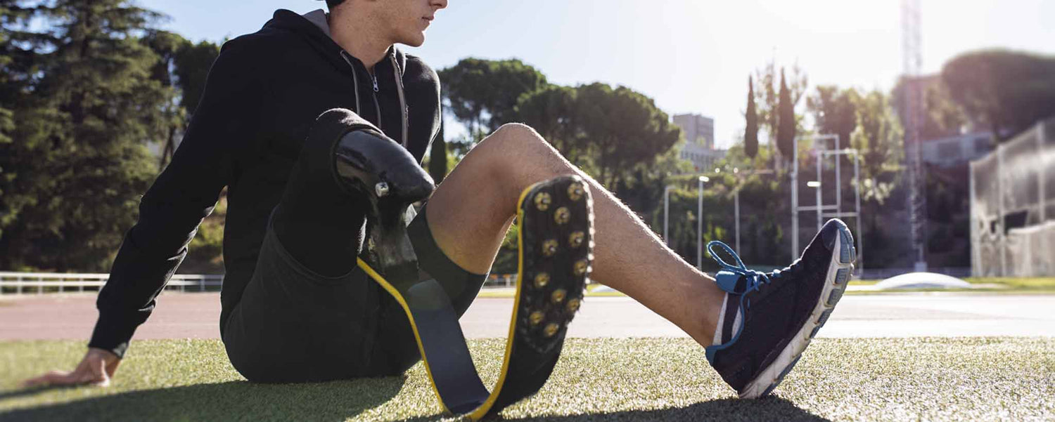 Man seated with athletic limb prosthesis