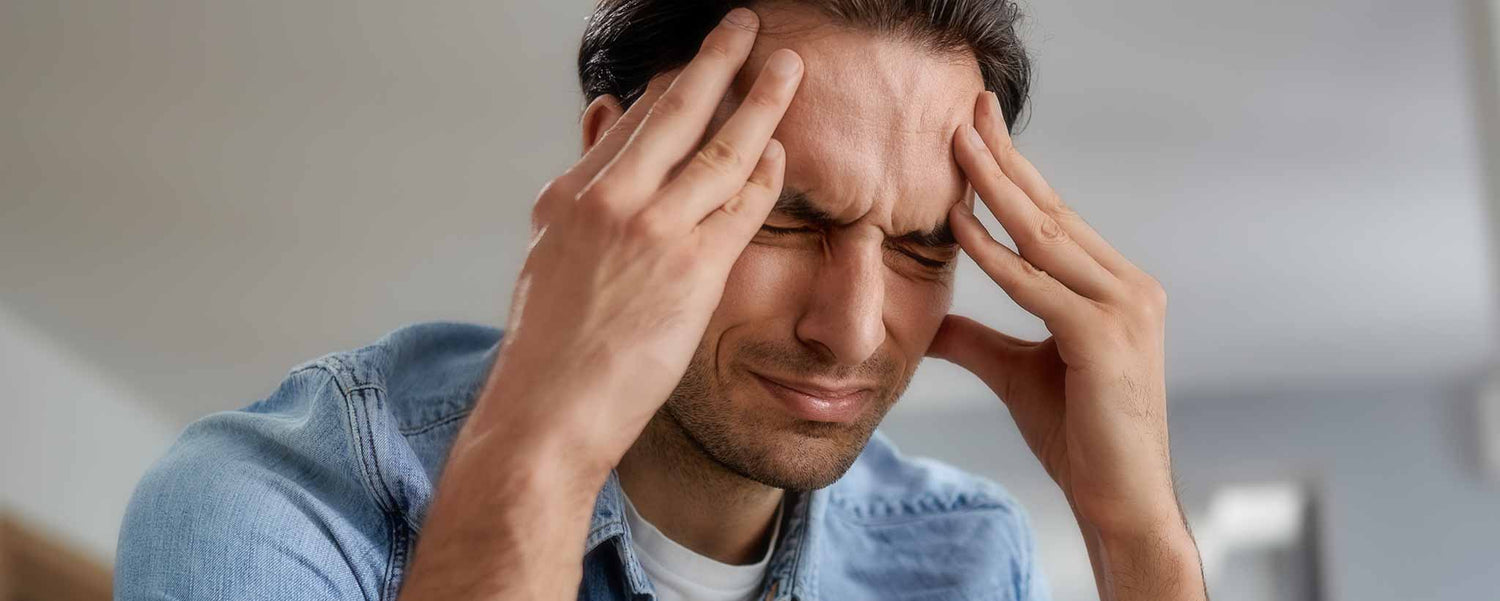 Man with hands on forehead