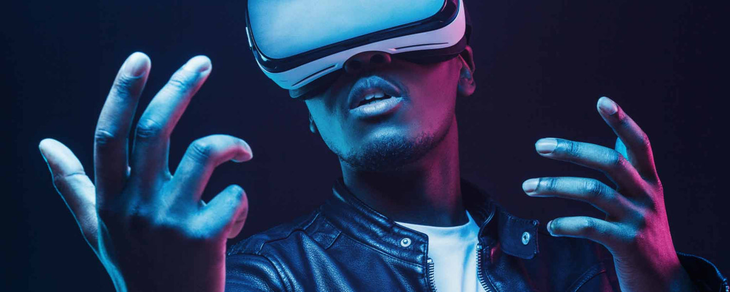 An African American male wears virtual reality glasses.