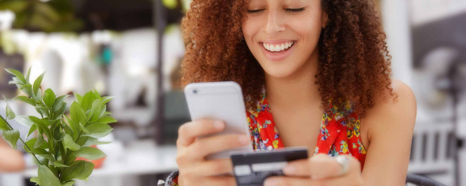 Beautiful female making outdoor online payment