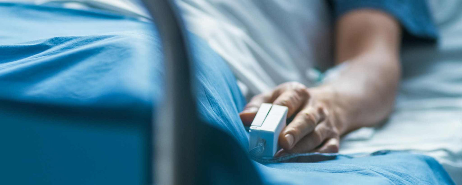 Hospital patient's hand with an oximeter.