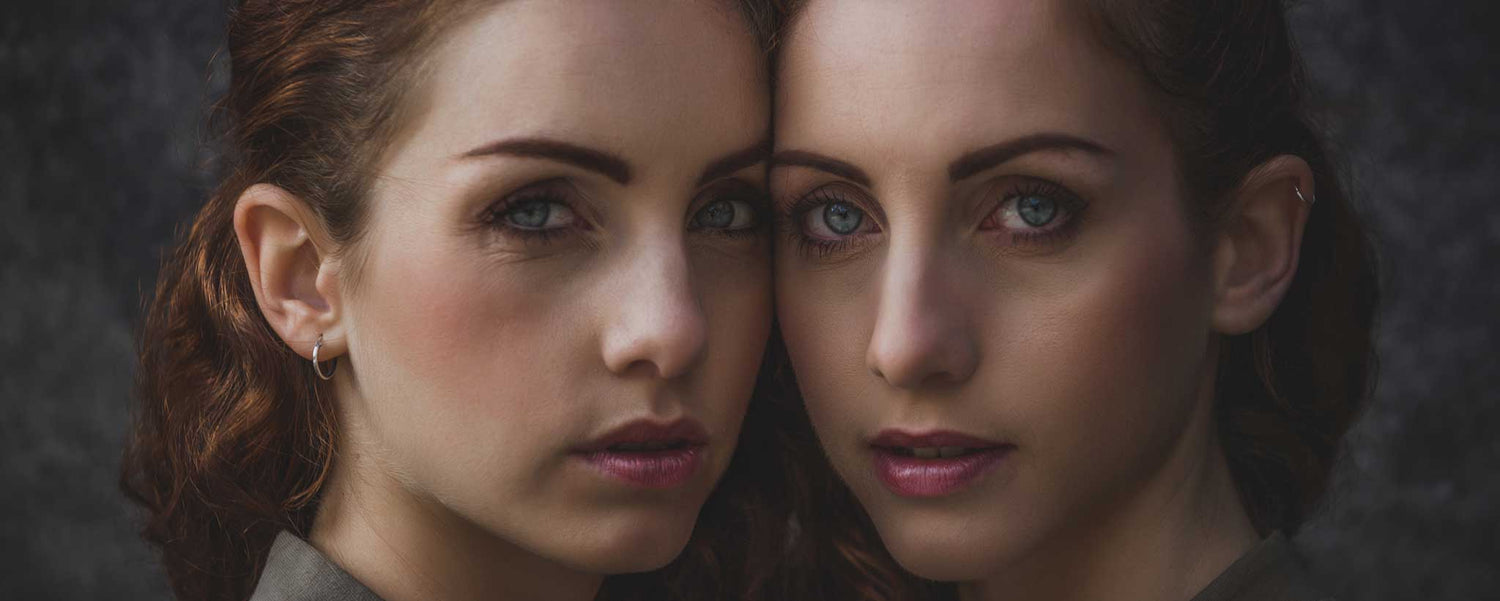 Twin sisters whisper between door