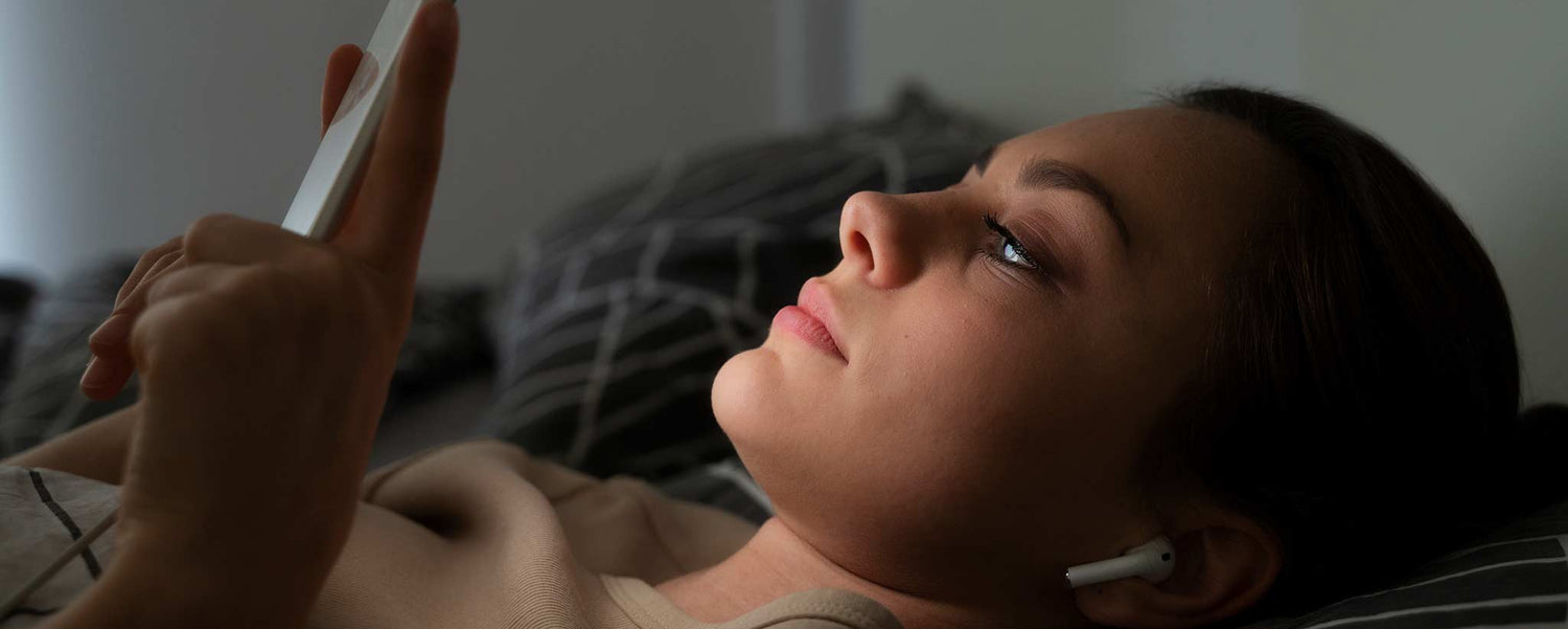 Female in bed with phone