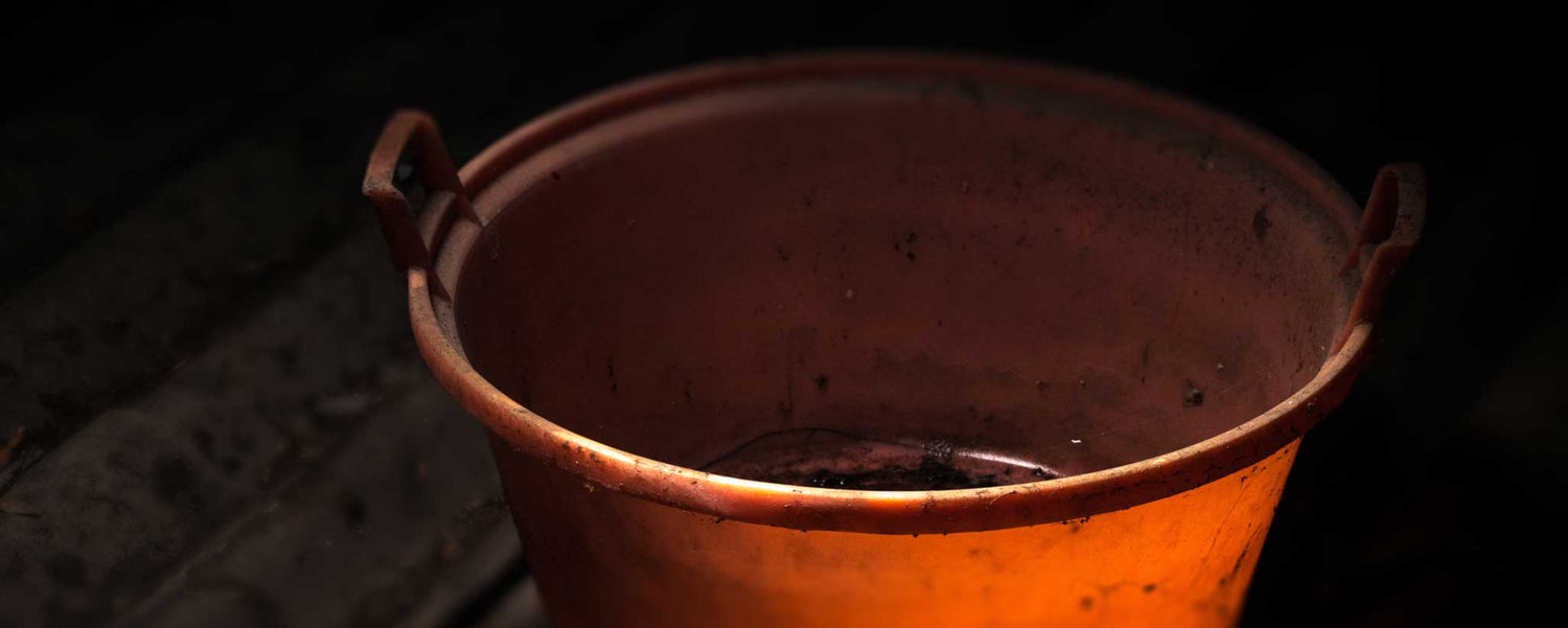 A dirty orange bucket.