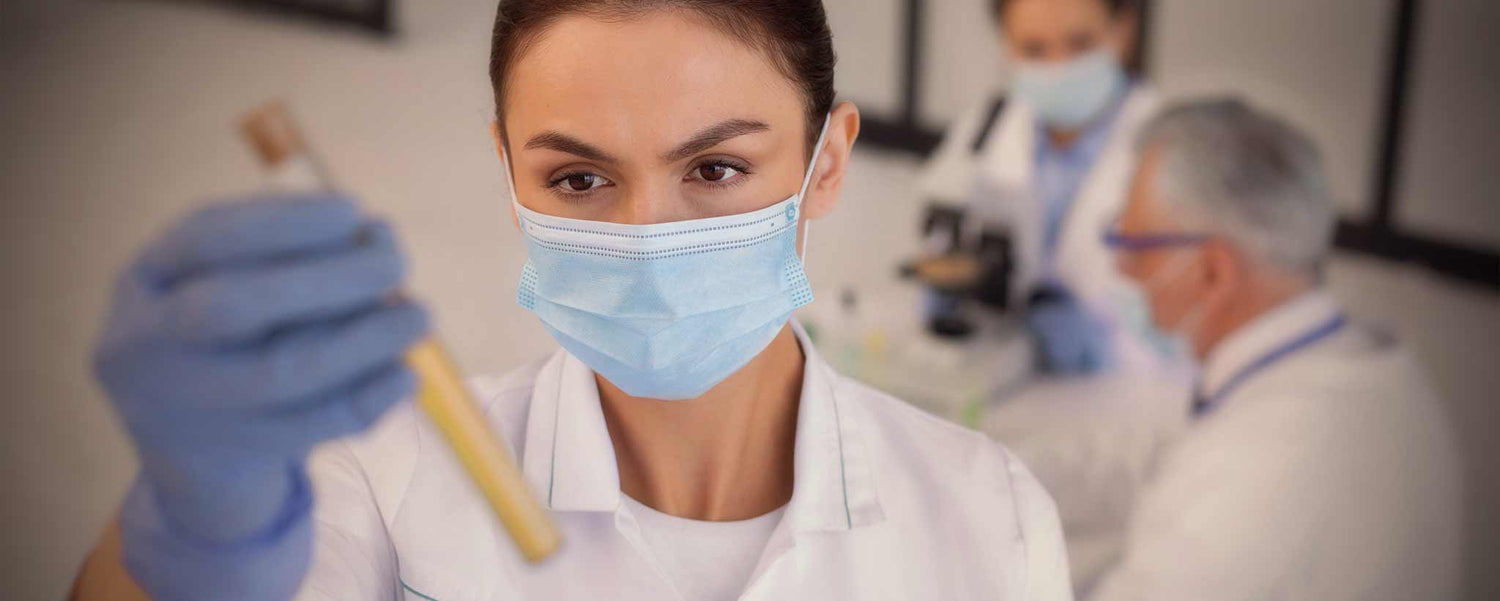 A female scientist holds test tube.