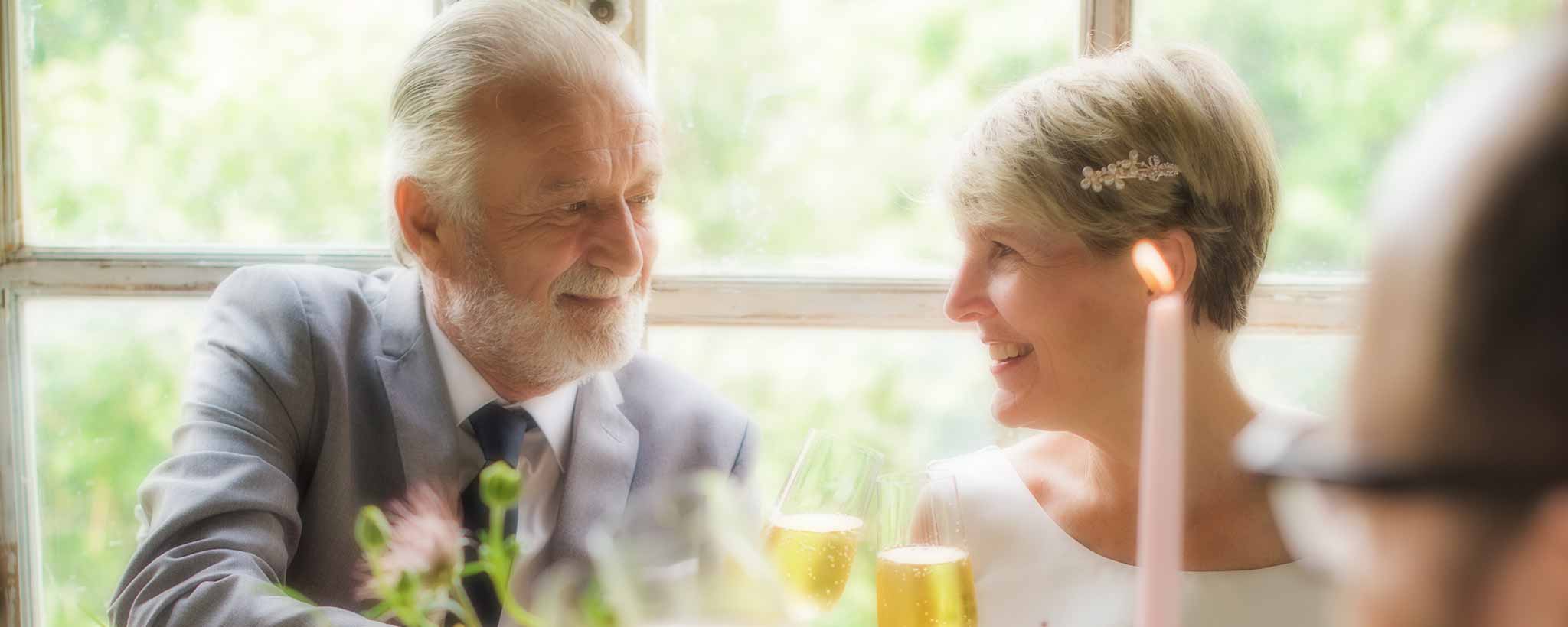 'Seniors enjoy their anniversary restaurant dinner.'