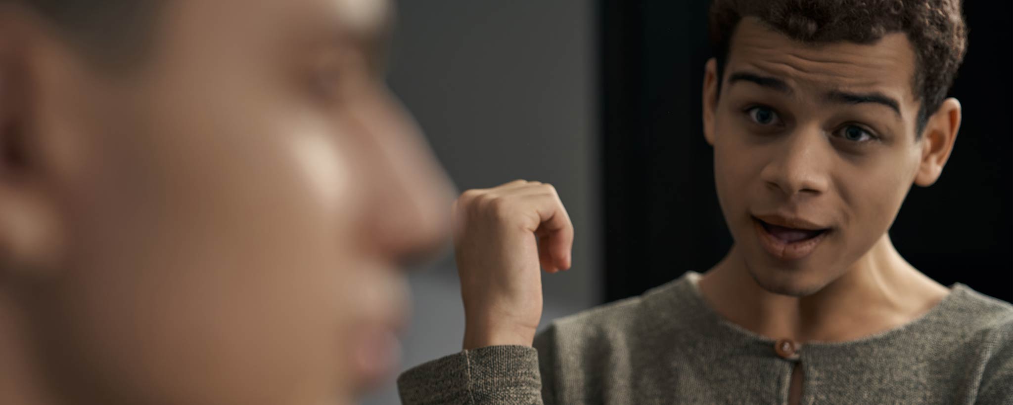 'A close-up of two young men disagreeing. '