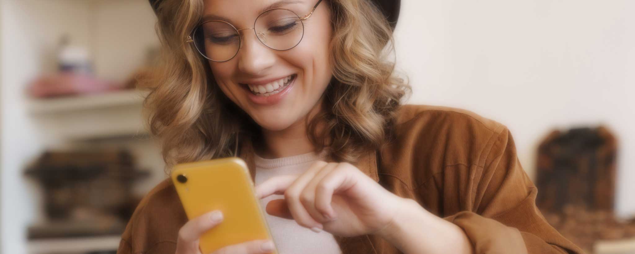 'Young woman reading phone message'