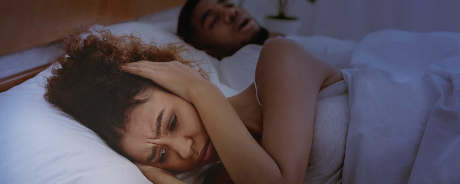 Snoring couple in bed