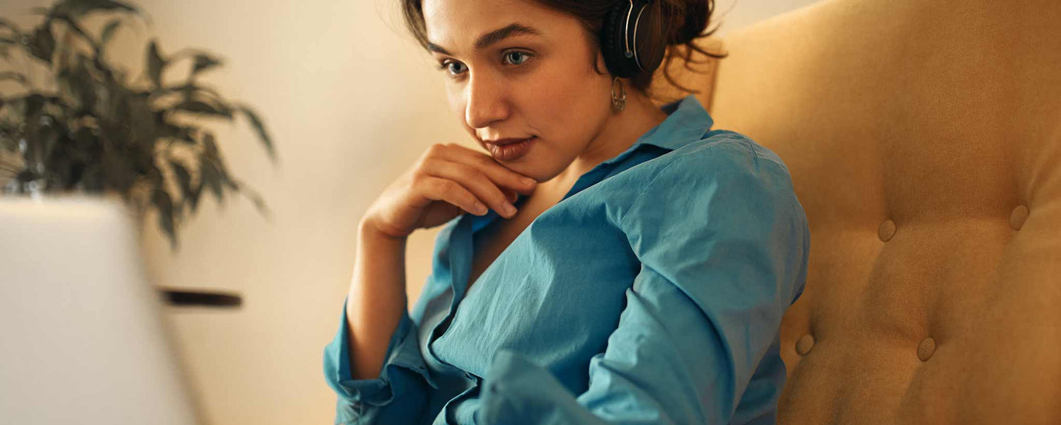 Female using computer on sofa