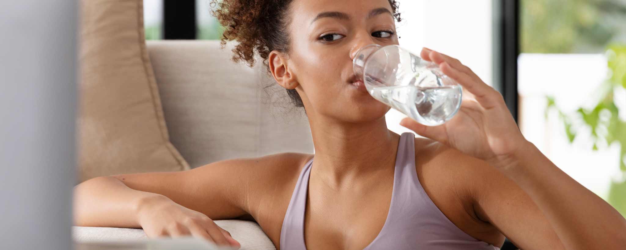 'Young woman drinking water'