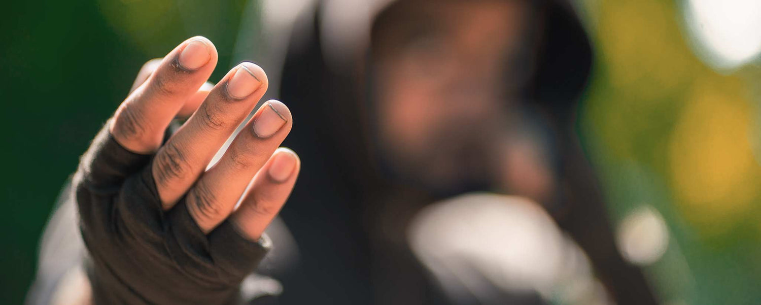 A male hooded street fighter beckons a challenge.