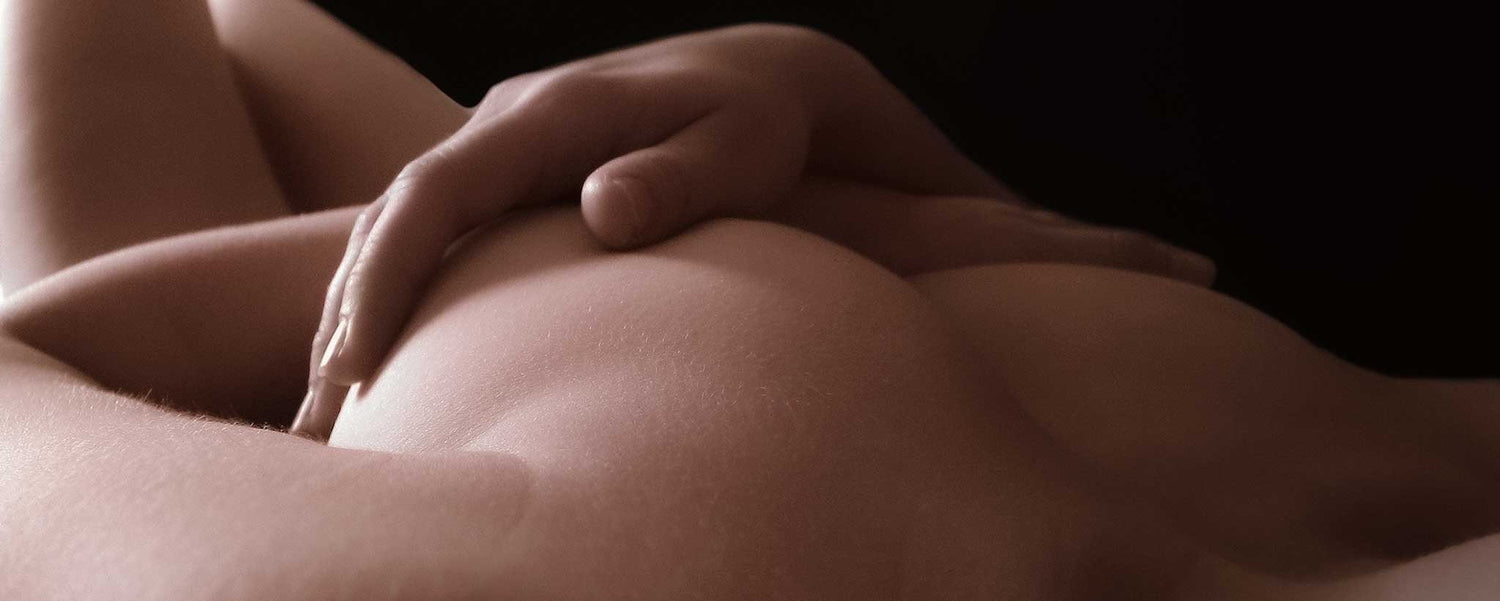 Supine nude female in shadows