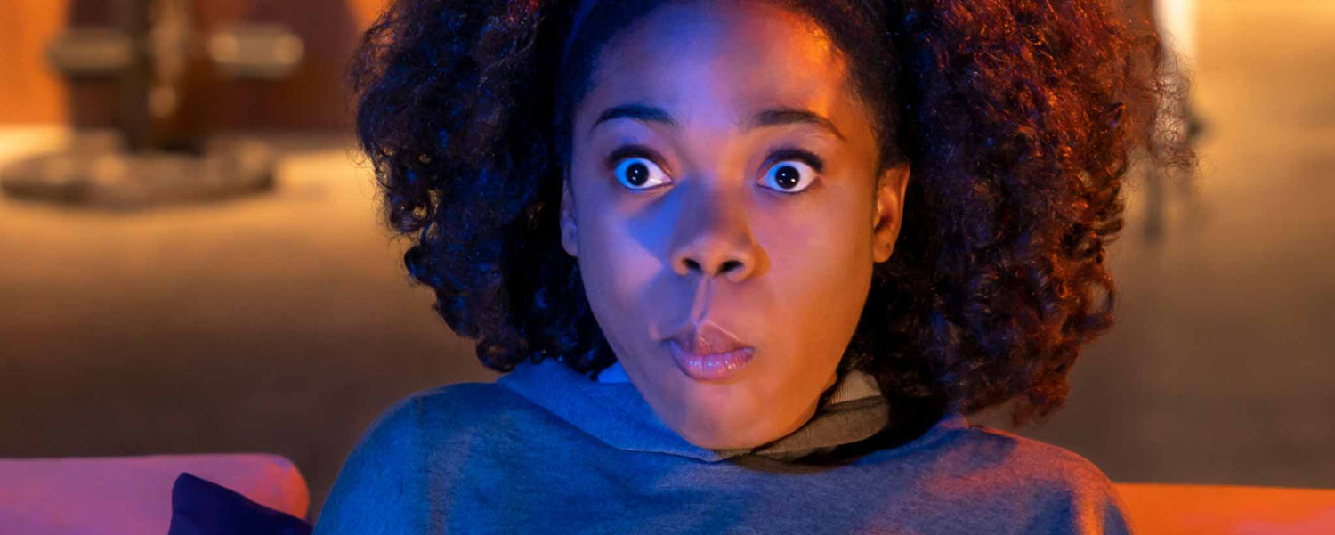 Surprised female watching television