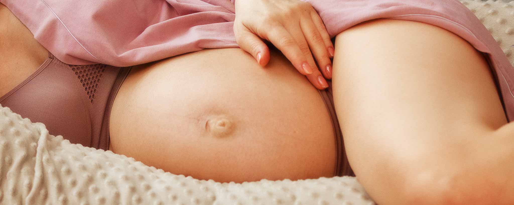 'Pregnant mother with legs crossed'