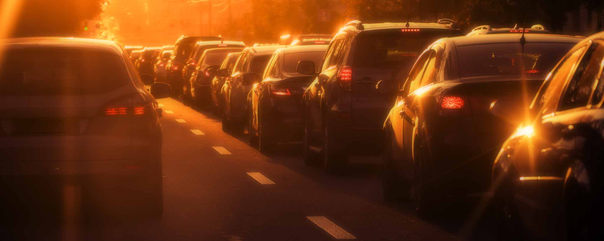 'A traffic jam under the amber sunset.'